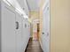 Bright hallway with built-in storage and wood-look tile, leading to open living space at 1333 W Yale St, Orlando, FL 32804