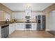 Well-equipped kitchen featuring stainless steel appliances, granite countertops, and white cabinetry at 1333 W Yale St, Orlando, FL 32804