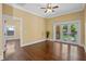 Spacious living room with hardwood floors, baseboard trim, ceiling fan, with a view of the yard at 1333 W Yale St, Orlando, FL 32804