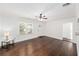 Bright living room with hardwood floors, large windows, and a ceiling fan at 1333 W Yale St, Orlando, FL 32804
