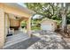 Backyard features a covered patio with built-in bar, white chairs, and a detached two-car garage at 1333 W Yale St, Orlando, FL 32804