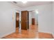 Well-lit bedroom featuring wood floors and an attached mirrored closet for ample storage at 1510 Jaguar Cir, Apopka, FL 32712