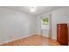 Well-lit bedroom features hardwood floors and neutral paint to suit any aesthetic at 1510 Jaguar Cir, Apopka, FL 32712