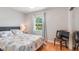 Bright bedroom with hardwood floors and mirrored closet at 1510 Jaguar Cir, Apopka, FL 32712