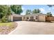 A single Gathering home with a gray garage door and grey accent trim with a curved driveway at 1510 Jaguar Cir, Apopka, FL 32712