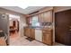 Well-lit kitchen offers wooden cabinets, a new dishwasher and tile countertops at 1510 Jaguar Cir, Apopka, FL 32712