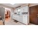 Bright kitchen with stainless refrigerator, white cabinets, and colorful backsplash at 1510 Jaguar Cir, Apopka, FL 32712