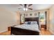 Spacious bedroom with wood floors, ceiling fan, natural light, and bedside tables at 1510 Jaguar Cir, Apopka, FL 32712