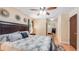 Comfortable main bedroom with ceiling fan, mirrored closet doors and decorative wall art at 1510 Jaguar Cir, Apopka, FL 32712