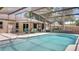 Gorgeous pool area with screened-in lanai and outdoor dining space at 1510 Jaguar Cir, Apopka, FL 32712