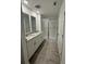 Modern bathroom featuring double sink vanity, a walk-in shower and tile floors at 16464 Happy Eagle Dr, Clermont, FL 34714