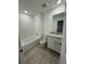 Bright bathroom featuring tile flooring, bathtub, and a vanity with white cabinets at 16464 Happy Eagle Dr, Clermont, FL 34714