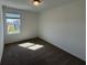 Bedroom with neutral carpeting, a window providing natural light, and ample space at 16464 Happy Eagle Dr, Clermont, FL 34714