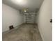 Attached single car garage with concrete flooring and overhead door at 16464 Happy Eagle Dr, Clermont, FL 34714
