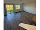 Living area with sliding glass door access to the backyard and tiled floors at 16464 Happy Eagle Dr, Clermont, FL 34714