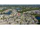 Wide aerial view of a Primary-planned community dotted with ponds, pools and mature trees at 2016 Cypress Bay Blvd, Kissimmee, FL 34743
