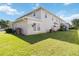 Large green backyard with lush grass and the back of a two-story house at 2016 Cypress Bay Blvd, Kissimmee, FL 34743