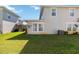 Large green backyard with lush grass and the back of a two-story house at 2016 Cypress Bay Blvd, Kissimmee, FL 34743