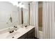 Bathroom featuring a double sink vanity and shower with neutral tile at 2016 Cypress Bay Blvd, Kissimmee, FL 34743