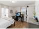 Bright bedroom with wood floors, natural light, and a functional workspace at 2016 Cypress Bay Blvd, Kissimmee, FL 34743