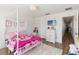 Pretty pink bedroom featuring a canopy bed, wood flooring and stylish decor at 2016 Cypress Bay Blvd, Kissimmee, FL 34743