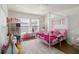 Beautiful pink bedroom with a canopy bed, pink accents, and cute Barbie decor at 2016 Cypress Bay Blvd, Kissimmee, FL 34743