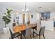 Open-concept dining room with modern lighting, seating for six, seamlessly connecting to the kitchen and living spaces at 2016 Cypress Bay Blvd, Kissimmee, FL 34743