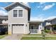 Charming two-story home with a front porch, a well-manicured lawn and an attached garage at 2016 Cypress Bay Blvd, Kissimmee, FL 34743