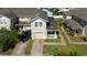 Two-story home with a well-kept lawn, brick driveway, and front porch at 2016 Cypress Bay Blvd, Kissimmee, FL 34743