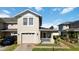 Charming two-story home with a front porch, a well-manicured lawn and an attached garage at 2016 Cypress Bay Blvd, Kissimmee, FL 34743