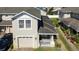 Aerial view of a well-maintained home with a garage, landscaping, and a great roof at 2016 Cypress Bay Blvd, Kissimmee, FL 34743