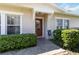 Charming home exterior featuring a brick walkway and lush landscaping around the front door at 2016 Cypress Bay Blvd, Kissimmee, FL 34743