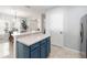 Charming kitchen island with blue cabinetry offering a view into the dining area, and stainless steel refrigerator at 2016 Cypress Bay Blvd, Kissimmee, FL 34743