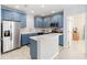 Stylish kitchen with blue cabinets, stainless steel appliances, and ample counter space for cooking at 2016 Cypress Bay Blvd, Kissimmee, FL 34743