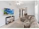 Inviting living room with stylish decor, a large TV, and open access to the dining area at 2016 Cypress Bay Blvd, Kissimmee, FL 34743