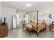 Inviting main bedroom with a canopy bed, stylish furnishings, neutral tones, and ample natural light at 2016 Cypress Bay Blvd, Kissimmee, FL 34743