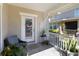 Welcoming front porch with chair, lush plants, and a 'Welcome' sign on the door at 2016 Cypress Bay Blvd, Kissimmee, FL 34743