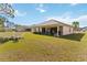 Large backyard with a patio, perfect for outdoor entertaining and relaxation at 20335 Macon Pkwy, Orlando, FL 32833