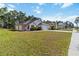 Well-maintained single-story home with a two-car garage, lush landscaping, and a green lawn at 20335 Macon Pkwy, Orlando, FL 32833