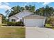 Charming single-story home featuring a two-car garage, tidy landscaping, and a well-maintained lawn at 20335 Macon Pkwy, Orlando, FL 32833