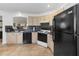 Kitchen featuring tile floors, neutral cabinetry, and updated black appliances at 20335 Macon Pkwy, Orlando, FL 32833