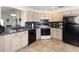 Bright kitchen features stainless steel sink, black appliances, and tile floors at 20335 Macon Pkwy, Orlando, FL 32833