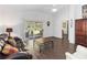 Spacious living room with wood floors, sliding glass doors to the patio, and comfortable seating at 20335 Macon Pkwy, Orlando, FL 32833