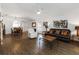 Open-concept living area with wood floors, a white ceiling fan, and a dining area at 20335 Macon Pkwy, Orlando, FL 32833