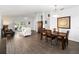 Open-concept living and dining area with wood floors, comfortable furniture, and plenty of natural light at 20335 Macon Pkwy, Orlando, FL 32833