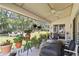 Relaxing patio with a ceiling fan, grill, comfortable seating and backyard views at 20335 Macon Pkwy, Orlando, FL 32833