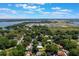 Aerial view of a neighborhood near a lake, showcasing lush greenery and a mix of residential homes at 219 Stribling Dr, Auburndale, FL 33823