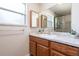 Bathroom featuring a vanity with a marble countertop, framed mirrors, and a shower with glass doors at 219 Stribling Dr, Auburndale, FL 33823
