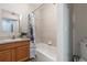 Cozy bathroom featuring a vanity, a mirror, a shower with a blue floral curtain, and a toilet at 219 Stribling Dr, Auburndale, FL 33823