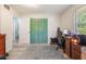Bedroom with wood-look floors, and closet with unique bi-fold doors, desk with computer, and neutral decor at 219 Stribling Dr, Auburndale, FL 33823
